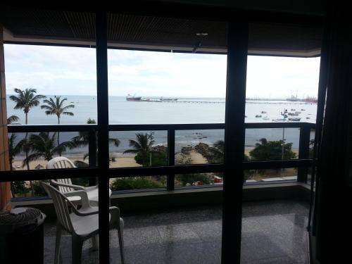 a view of the ocean from a room with a window at Iracema Residence Hotel Flat in Fortaleza