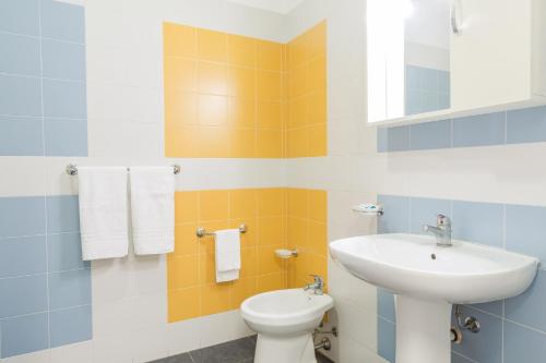 a bathroom with a sink and a toilet at Casa per Ferie Don Orione Palermo in Palermo