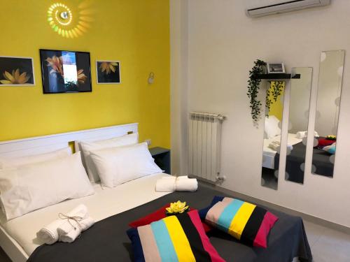 a bedroom with a bed and a yellow wall at B & B Il Giardino sul Mare in Briatico
