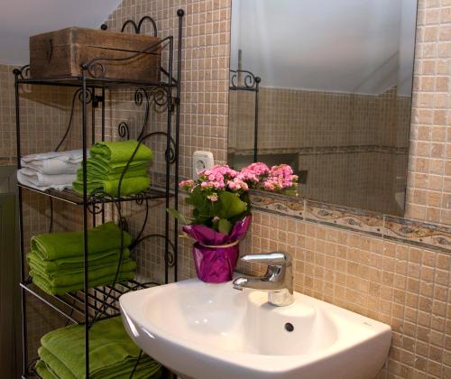 a bathroom with a sink and a vase of flowers at Villa Alegre Playa Calpe Grupo Terra de Mar, alojamientos con encanto in Calpe