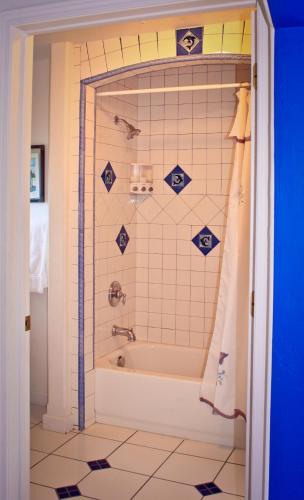 a bathroom with a tub and a tiled shower at The Islander Inn in Bigfork
