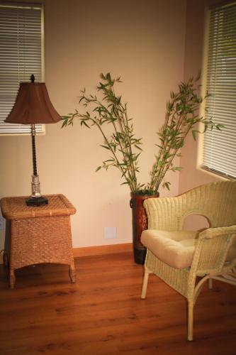 a living room with a chair and a table with a plant at The Islander Inn in Bigfork