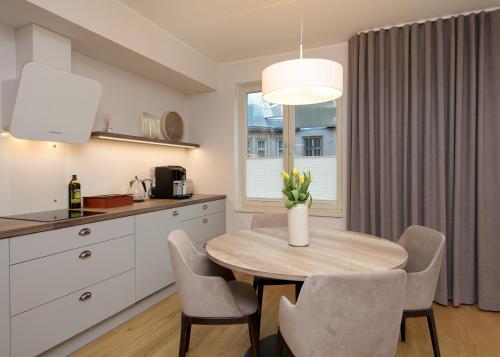 a kitchen and dining room with a table and chairs at TP City Apartment - City Center in Tallinn