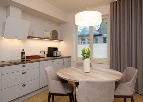 a kitchen and dining room with a table and chairs at TP City Apartment - City Center in Tallinn