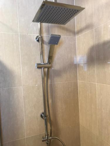 a shower with a shower head in a bathroom at Castillo Sun Bungalow in Caleta De Fuste