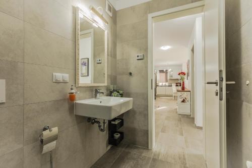 a bathroom with a sink and a mirror at Elegant Sophia's Apartment in Braşov