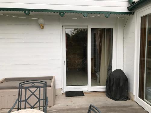 a front porch with a glass door and a chair at House at Lake "Alte Donau" in Vienna in Vienna