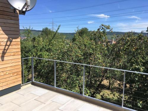 a balcony with a view of an apple orchard at Ferienwohnungen Weinstadt in Weinstadt