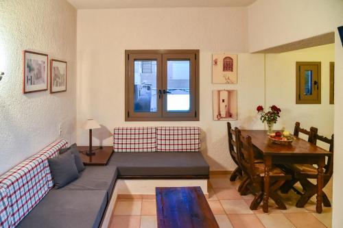 a living room with a couch and a table at Porto Sisi Hotel Apartments in Sissi