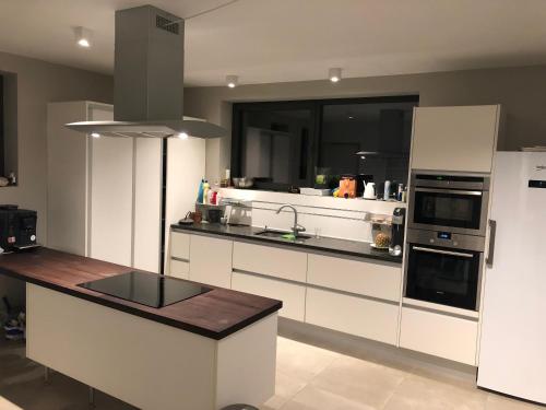 a kitchen with white cabinets and a counter top at Joff in Budingen