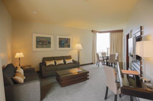 a living room with a couch and a table at Delfines Hotel & Convention Center in Lima