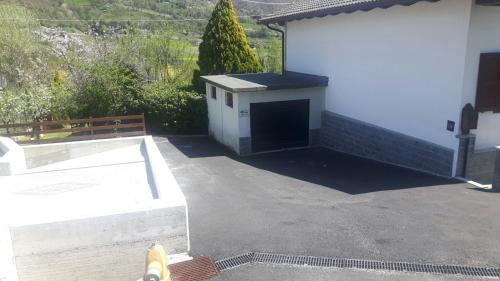 a patio with a white building with a stove at Casa Vacanze Germano in Aosta