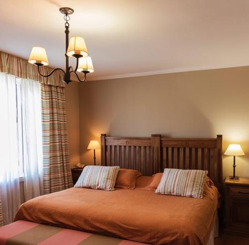 a bedroom with a bed with two pillows on it at Lo de Tomy in El Chalten