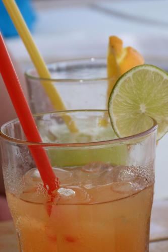 a drink in a glass with a slice of lime at Villa Kuzmanić in Trogir