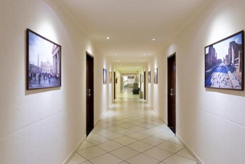 a hallway with paintings on the walls of a building at Aguas do Iguaçu Hotel Centro in Foz do Iguaçu