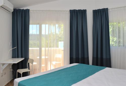a bedroom with a bed and a large window at Tropical Casa Laguna in Cabarete
