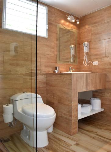 a bathroom with a toilet and a sink at Tropical Casa Laguna in Cabarete