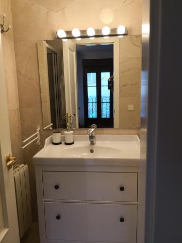 a bathroom with a sink and a mirror at La Casa de la Luna in Ávila