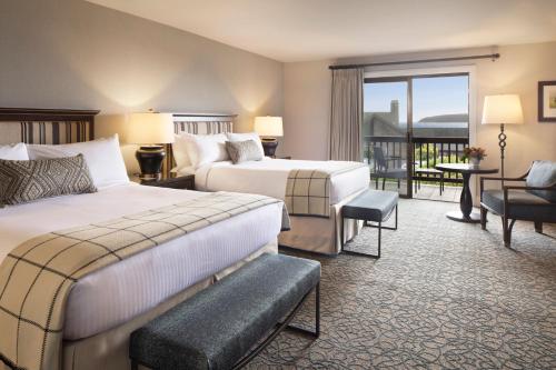 a hotel room with two beds and a balcony at The Lodge at Bodega Bay in Bodega Bay