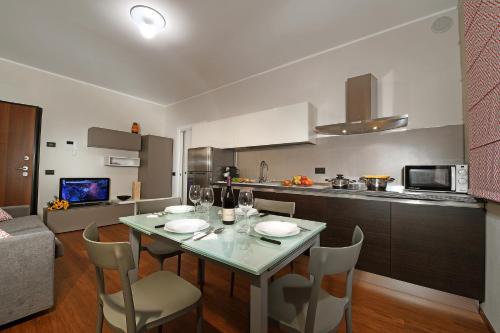 a kitchen and dining room with a table and chairs at LaGare in Neive