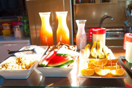 a table topped with two plates of food and fruit at Onkel Inn Wagon Sleepbox Uyuni in Uyuni