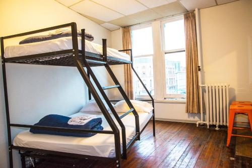 a room with two bunk beds and a window at The Cambie Hostel Gastown in Vancouver