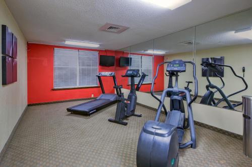 a gym with three tread machines in a room at Country Inn & Suites by Radisson, Lumberton, NC in Lumberton