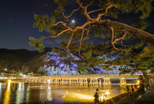 a view of the lake at night at Mulan Hostel in Kyoto