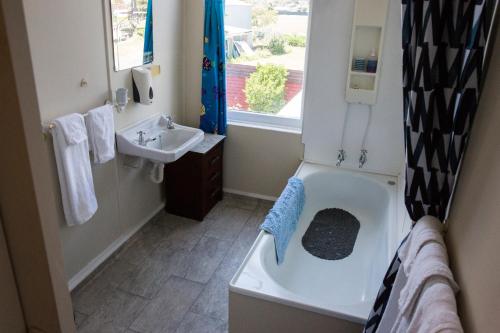 a bathroom with a bath tub and a sink at Post Office Hotel in Foxton