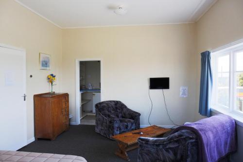 a living room with a couch and a table at Post Office Hotel in Foxton