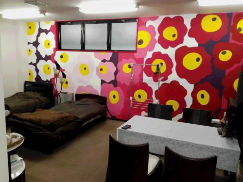 a room with a wall with flowers painted on it at Seikan bildinng101 in Hakodate