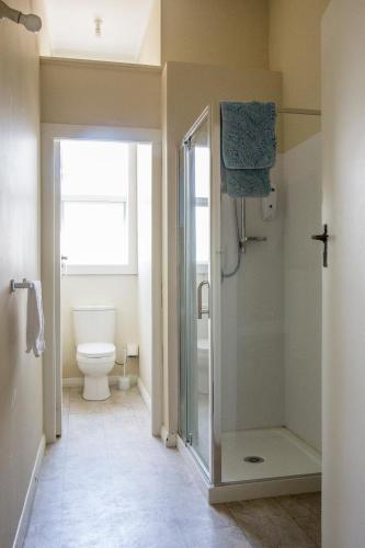 a bathroom with a shower and a toilet at Post Office Hotel in Foxton