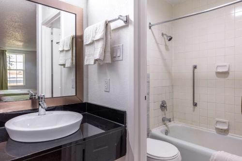 a bathroom with a sink and a tub and a toilet at Studio 6-Temple, TX in Temple