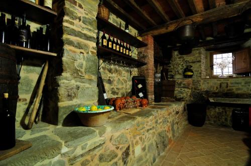 a stone room with a counter with a bowl of fruit at Casa Vacanze Le Muse Sillico in Pieve Fosciana