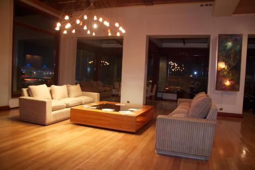 a living room with couches and a coffee table at Gran Hotel Vicente Costanera in Puerto Montt