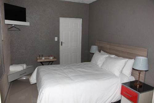View Inn Exclusive Lodge tesisinde bir odada yatak veya yataklar