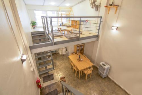 an overhead view of a room with a table and a staircase at Ekanake hostel in Bangkok
