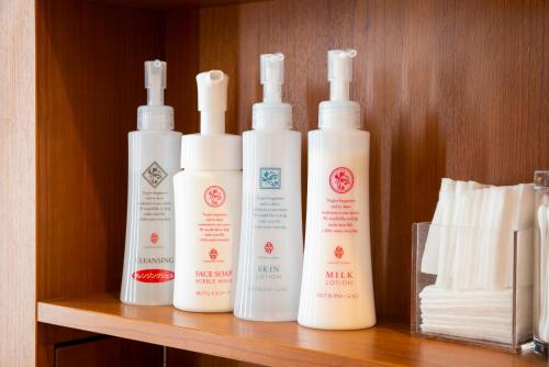 four bottles of moisturizers sitting on a shelf at First Cabin Ichigaya in Tokyo