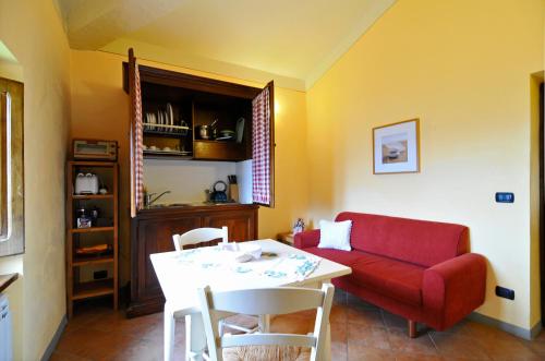 a living room with a red couch and a table at Casa Vacanze Le Muse Sillico in Pieve Fosciana