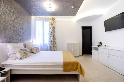 Postel nebo postele na pokoji v ubytování Hotel Duke Romana City Center