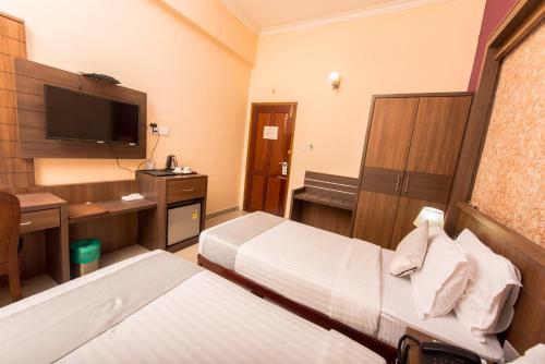 Postel nebo postele na pokoji v ubytování Kallada Golden Hotel