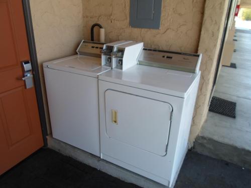 a white washer and dryer in a room at Economy Inn Morgan Hill in Morgan Hill