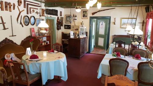 a restaurant with two tables in a room at Hodde Kro in Tistrup