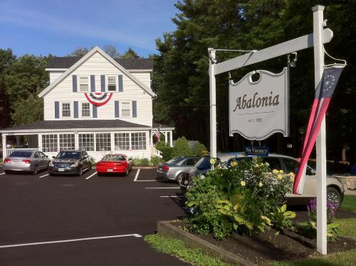 a parking lot with cars parked in front of a building at Abalonia Inn in Ogunquit