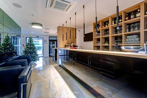 a bar in a restaurant with two christmas trees at Hotel Scala d'Oro in Vodice
