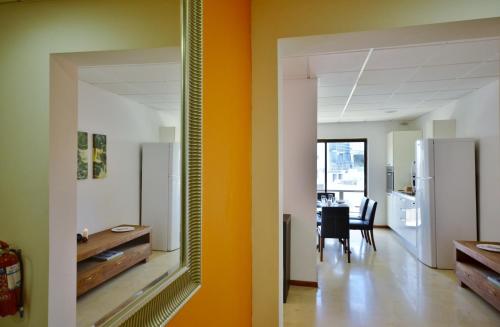 a room with a mirror and a kitchen with a table at City Living Suite Tk 2 Rm 4 in St. Julianʼs