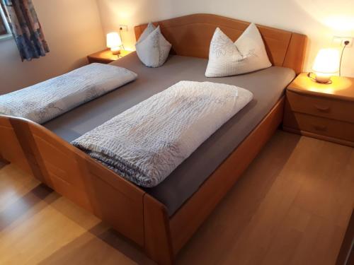 a bed with two pillows on it in a room at Ferienwohnungen Ferstl in Riedenburg