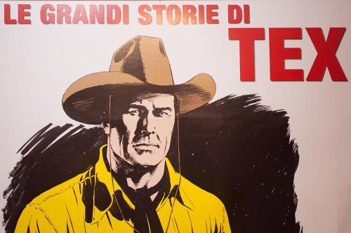 a poster of a man wearing a cowboy hat at Hotel Cineholiday in Naples