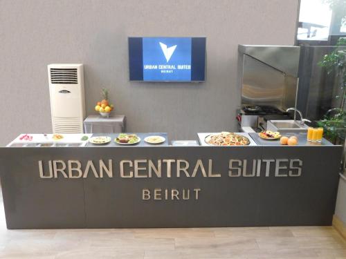 a sign for aufman central suites with food on a counter at Urban Central Suites - Beirut in Beirut