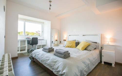 a bedroom with a large bed with two pillows on it at LUXURY GAVA BEACHFRONT APARTMENT BARCELONA in Gavà